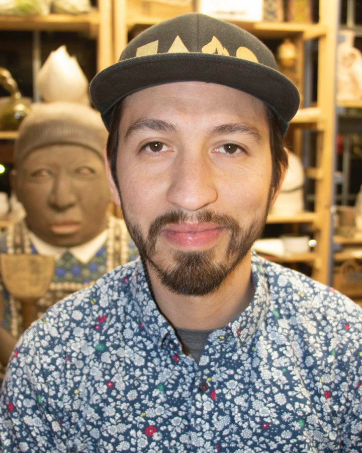 Artist poses with his sculpture.