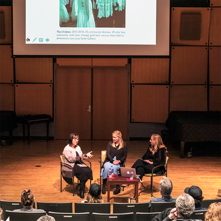 3 women sitting on stage discussing the work of Trina McKillen