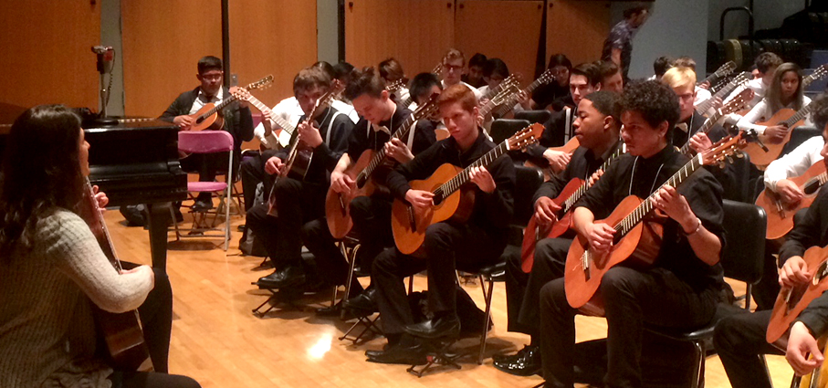 A group of students playing their guitars in Murphy Hall.