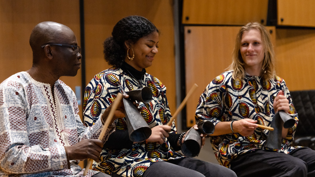 Students from the African Music Ensemble playing their instruments.