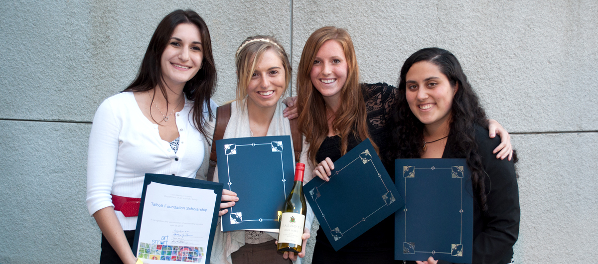 A group of students pose with their awards at an Art and Art History Awards event.