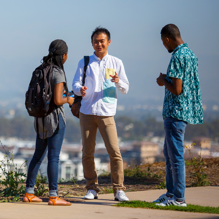 A group of people having a conversation on the bluff.