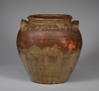 A photo of a gray background with a ceramic vase in the middle.