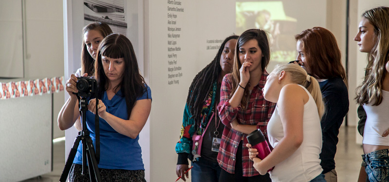 A group of students listening to a lecture in the Student Gallery.