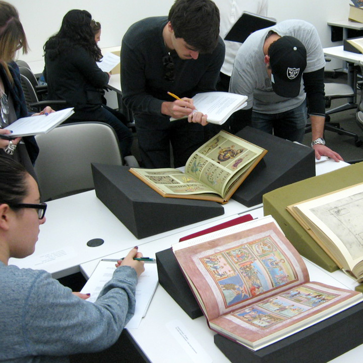 A group of students examining old books.