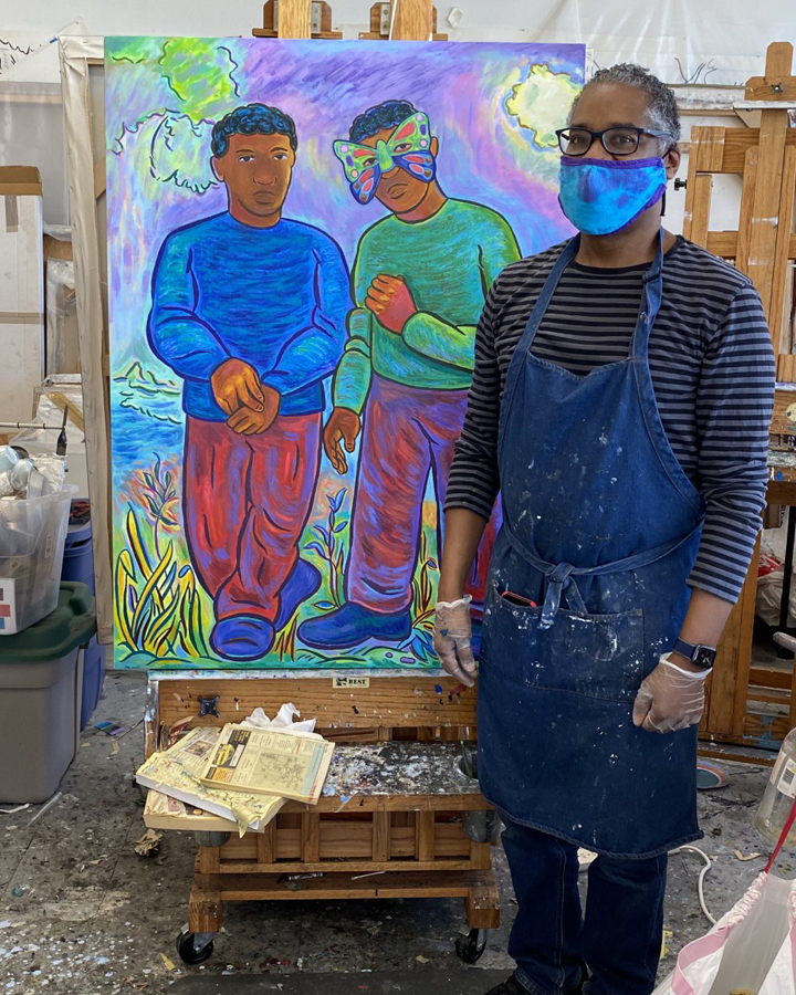 Artist standing in his studio with his painting.