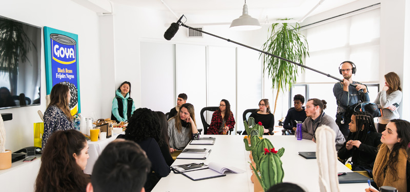 Two people presenting their product to a group.