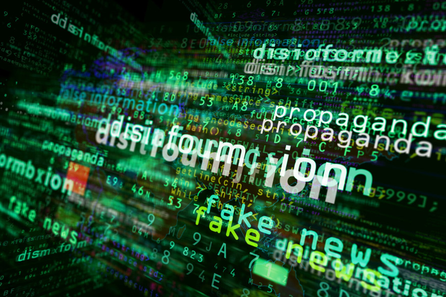 A cluster of words relating to misinformation and propaganda on a dark background.