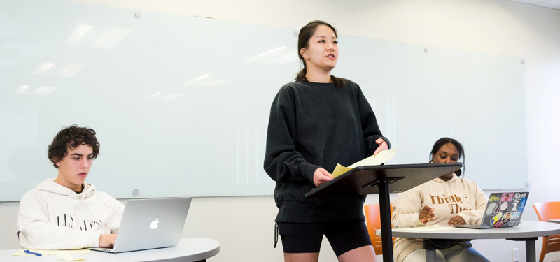 Three students participating in a communication studies class.