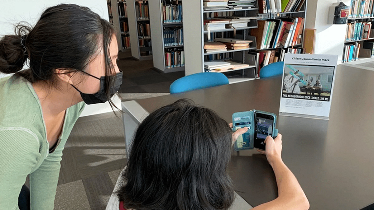 Two people using an app to create an augmented reality experience.