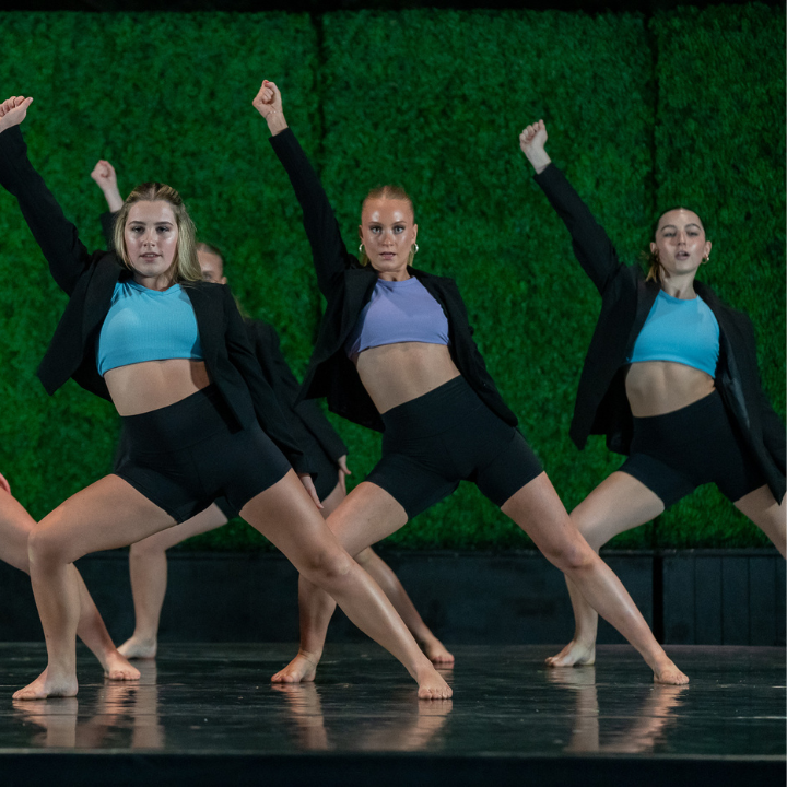 A group of dancers performing on the Drollinger Family Stage.