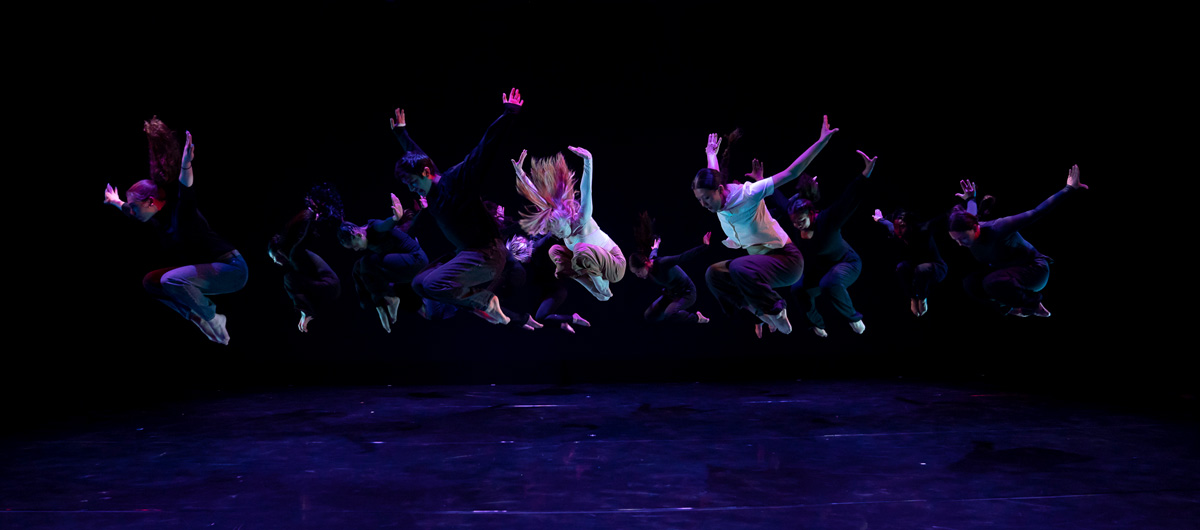A group of dancers leaping in the air.