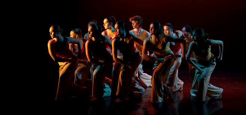 A group of dancers moving in unison.
