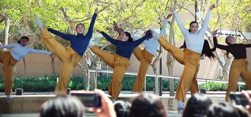 Dancers performing at the Drollinger Family Stage on a sunny day.
