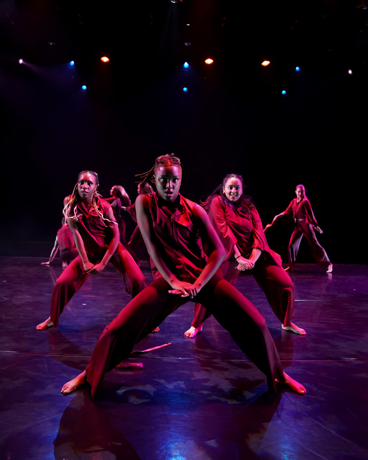 A group of dancers performing in red.