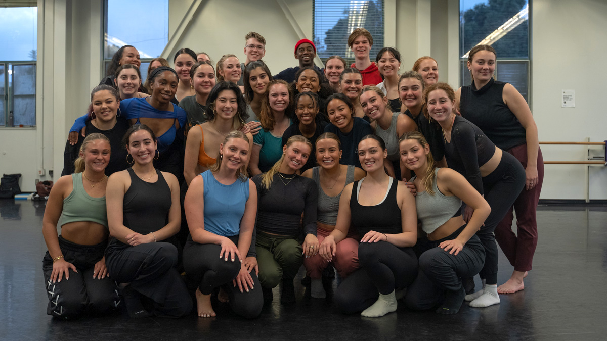 Dancers posing for a group photo in a studio.