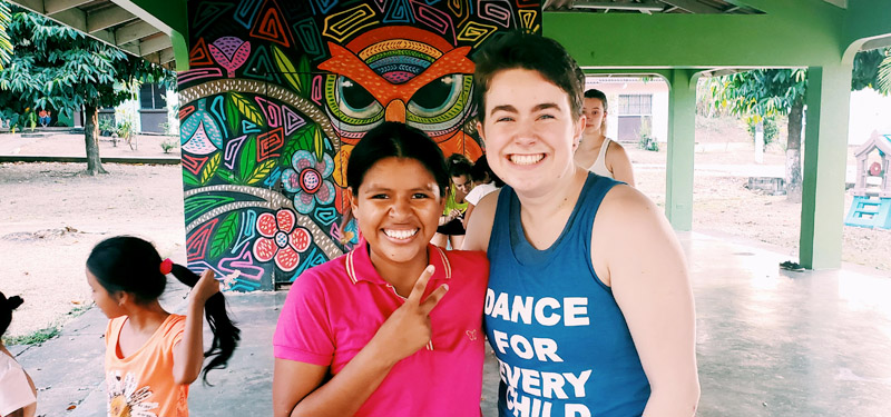 An LMU dance education student posing for a photo with a student in Panama.