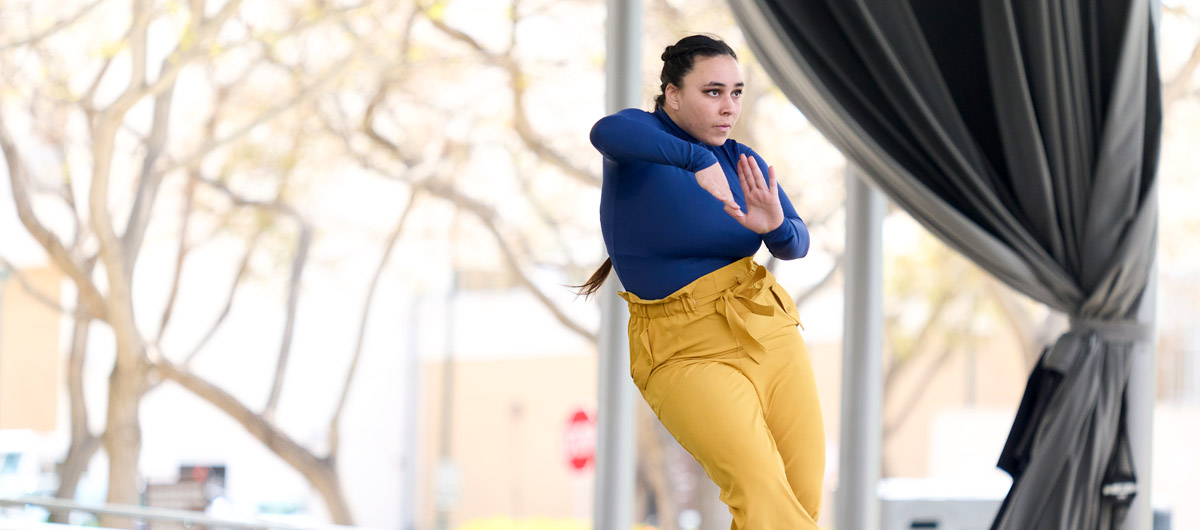 A dancer in blue and gold performing at the Drollinger Family Stage.