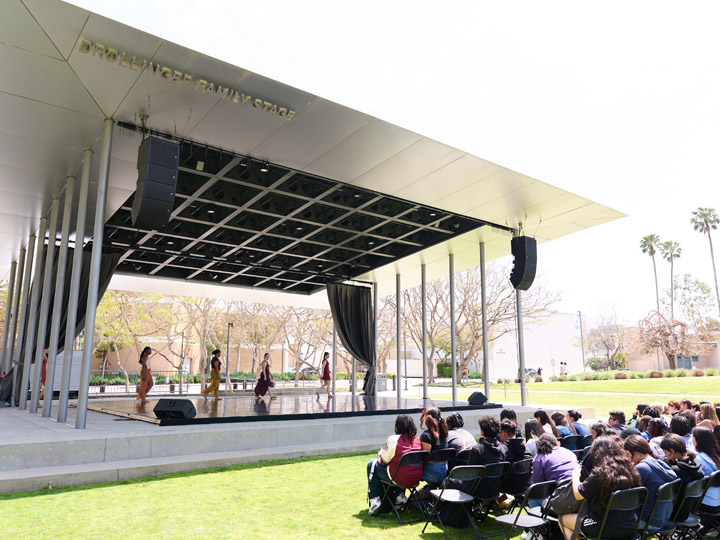 Dancers performing for an audience at the Drollinger Family Stage.