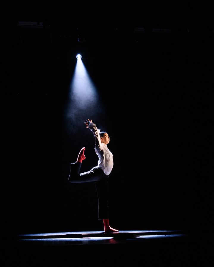 Dancer illuminated by spotlight at Fall '19 Faculty Concert.