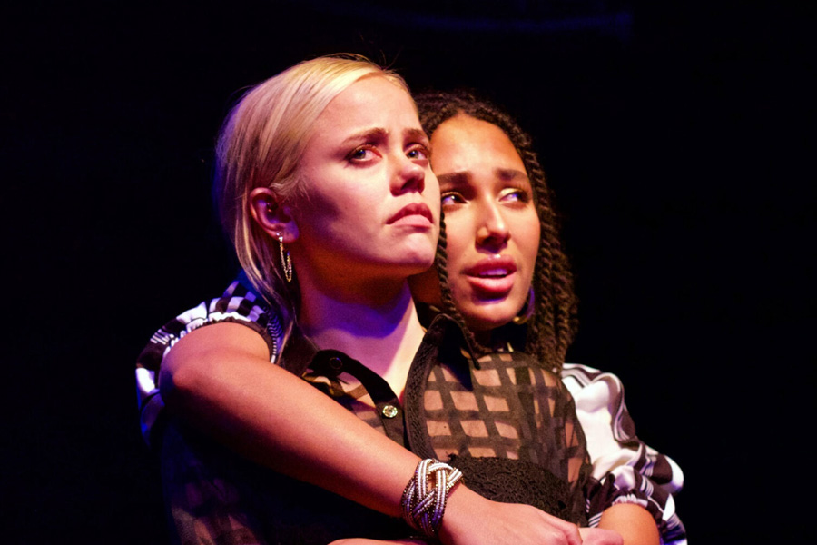 Two performers onstage in a performance of Romeo and Juliet.