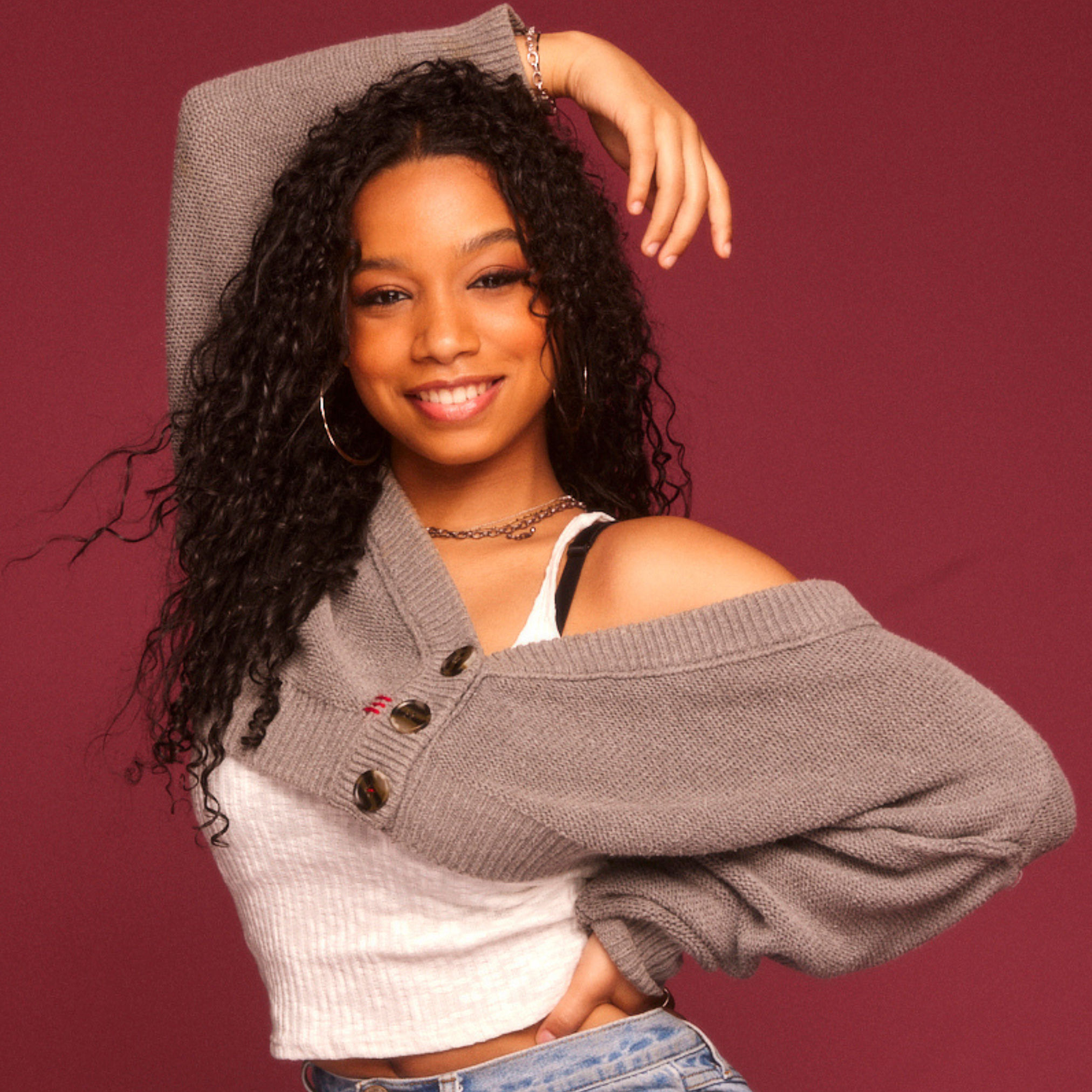 a woman posing with arm on top of her head
