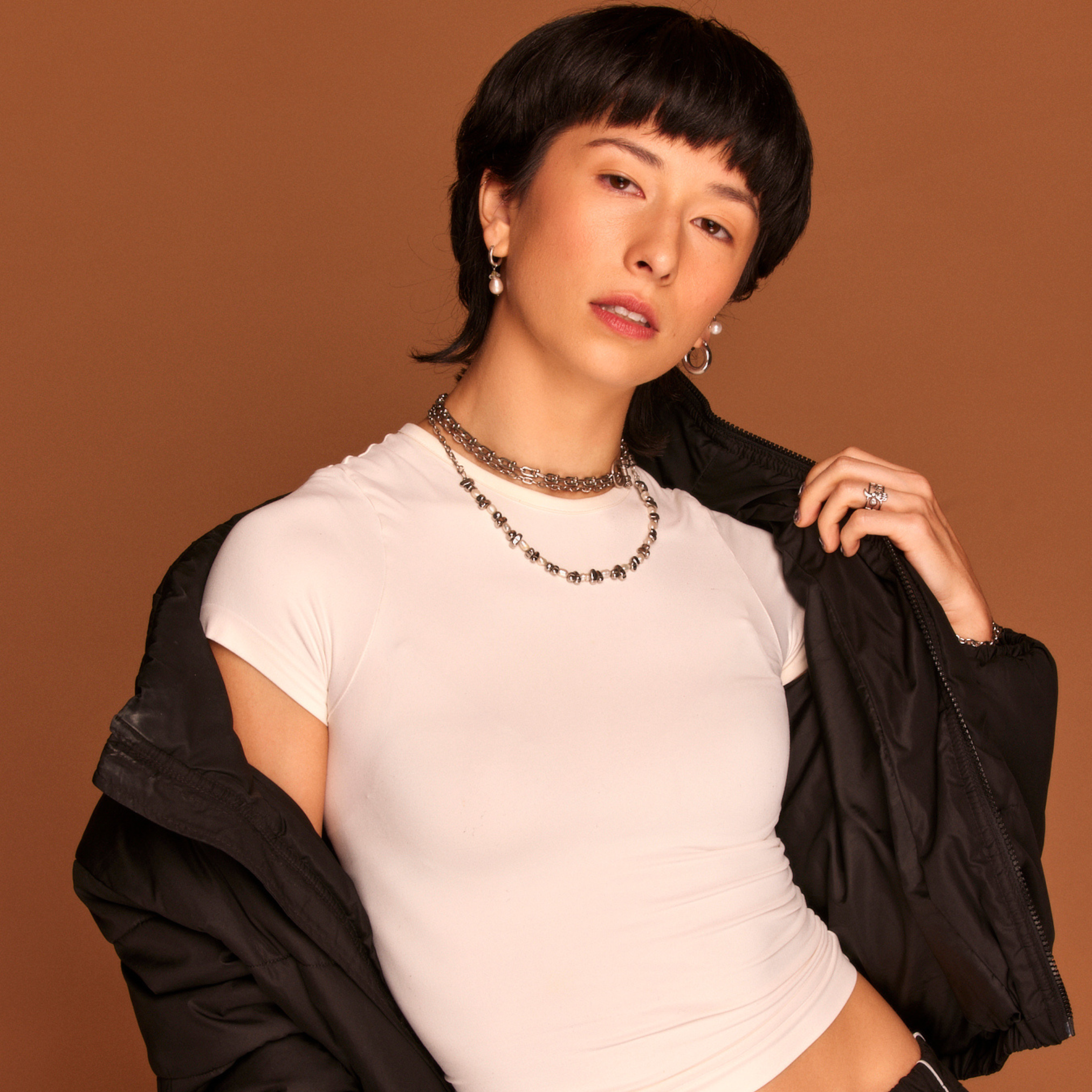 a woman in a white shirt posing.