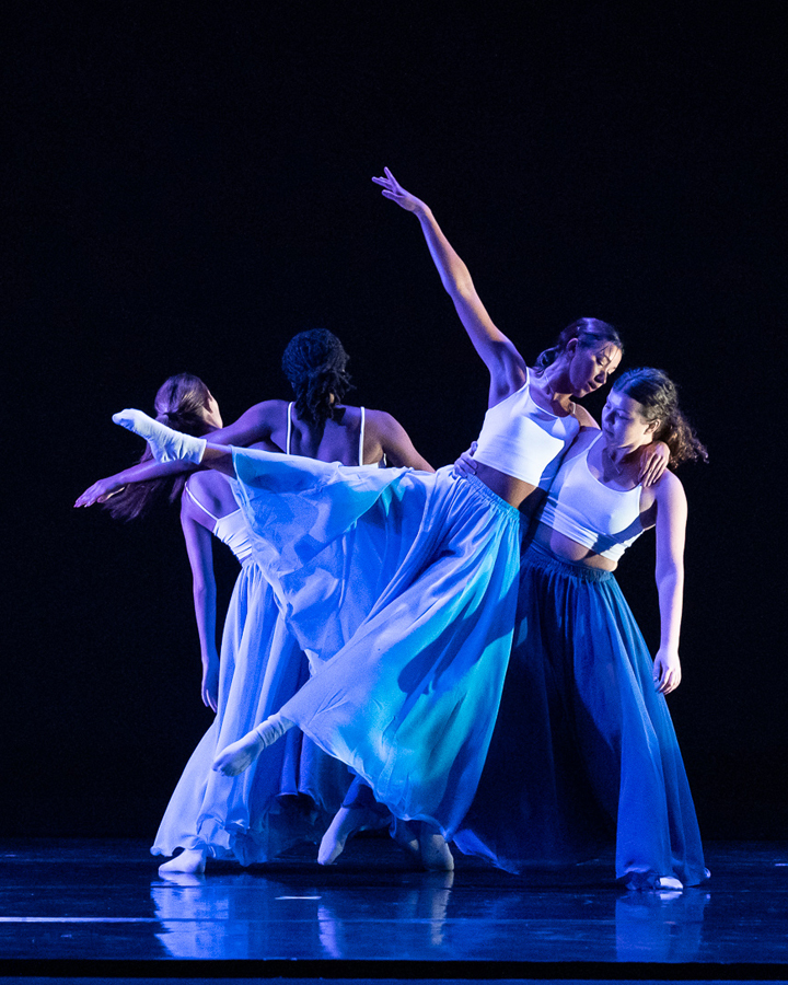 A group of dancers performing onstage at the Spring 2022 Student Concert.