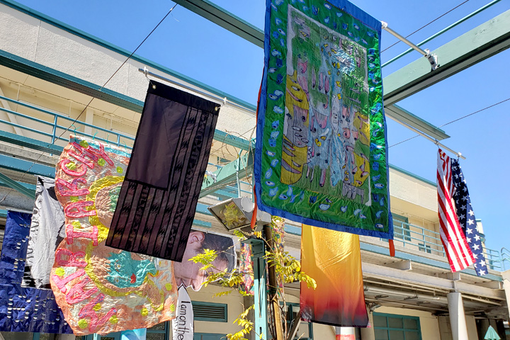 Flags and other artwork on display in Burns' courtyard.