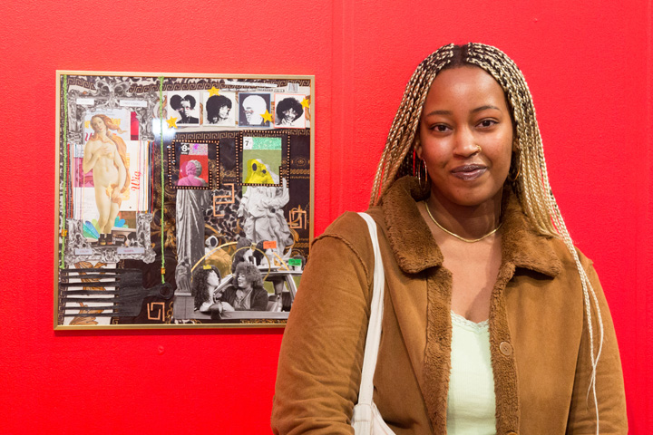An artist standing next to their artwork at the 2022 Young Contemporaries exhibition.