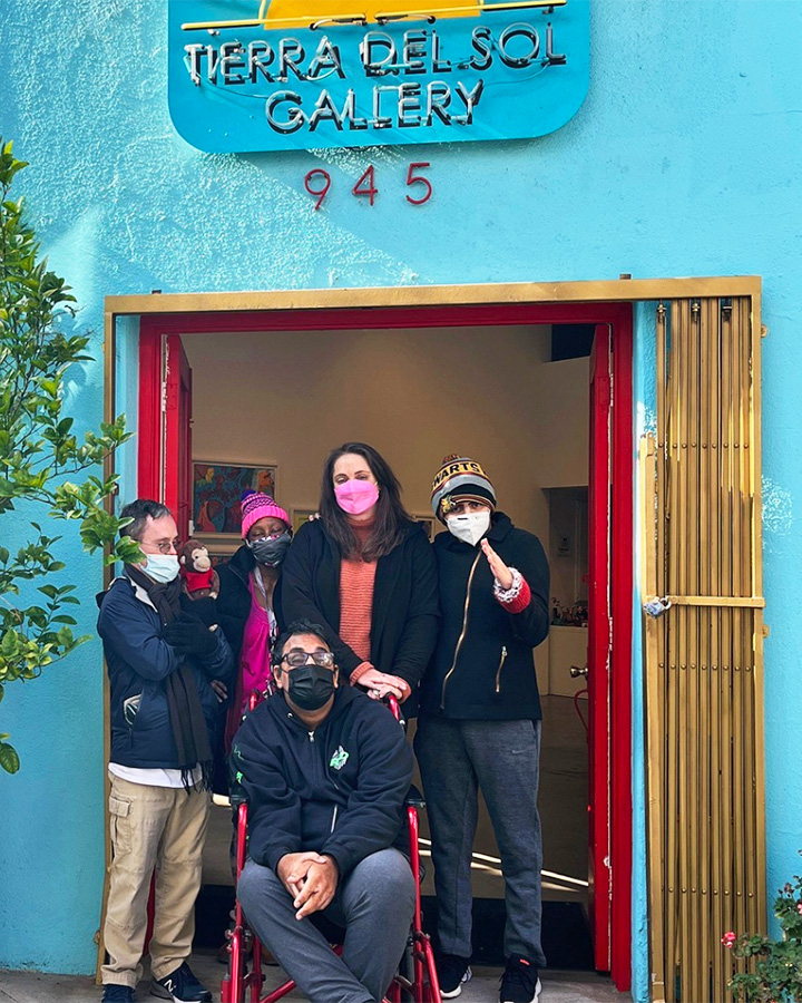 A group of artists in the doorway of their studio