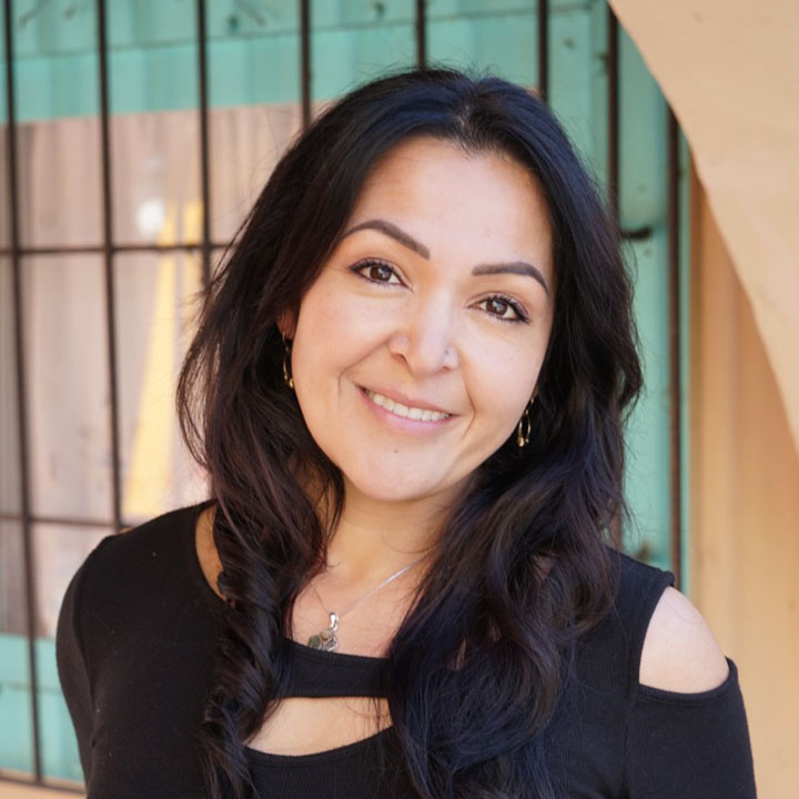 Photo of Melanie Morones standing near a window.