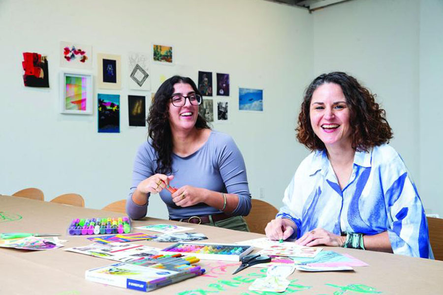 Two people at an art therapy gathering to support those affected by the wildfires.