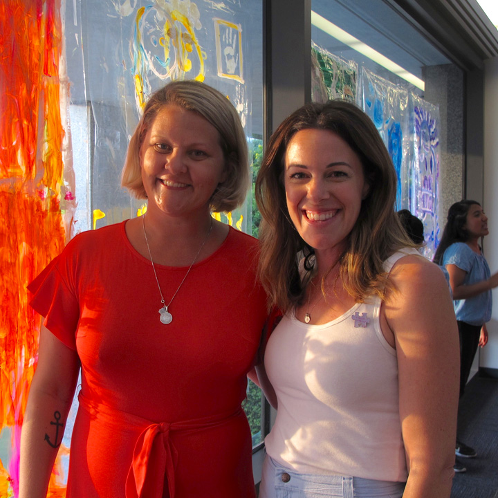 Two women posing for a photo during a Summer Arts Workshop event.