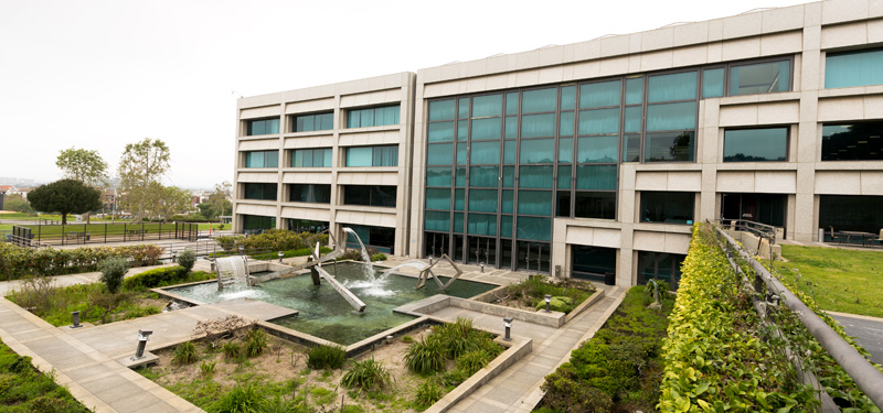 View of University Hall exterior with a fountain in the foreground.