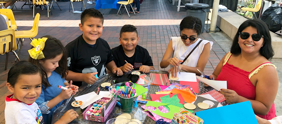 A group of people creating artwork at an event.