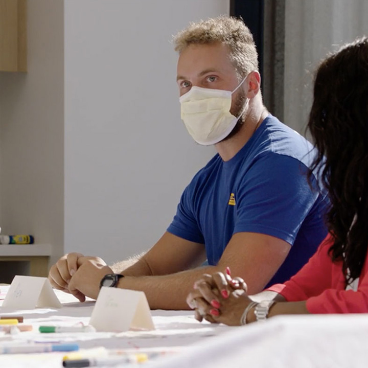 A LA Rams player participating in an art therapy workshop at a hospital.