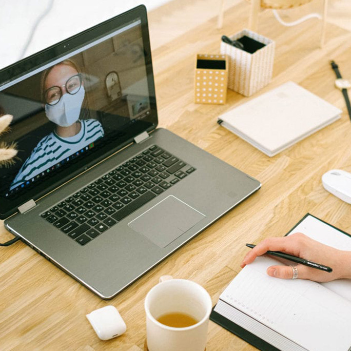 A person sitting at their desk for a telehealth call.