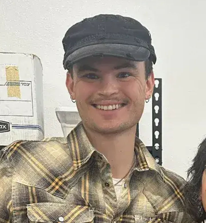 Photo of Tommy Mix in a button up shirt and hat.