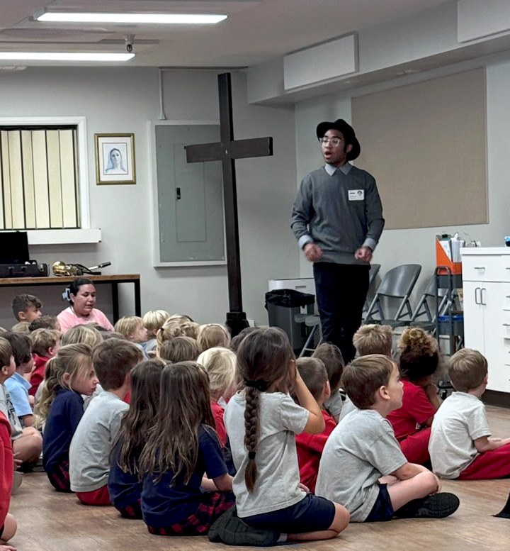 Donovan Claverie giving a presentation to young students.