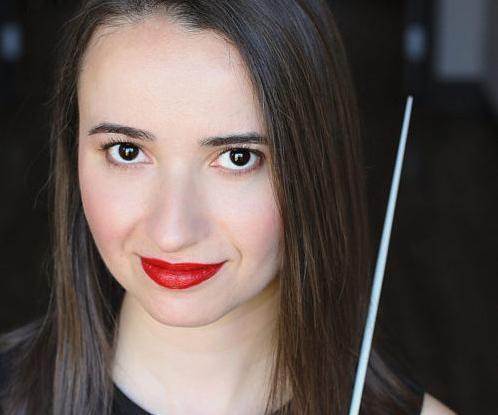 Headshot of a young white woman with dark hair and red lipstick.