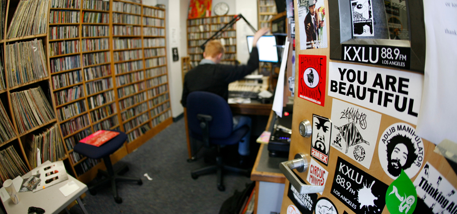 A student hosts a radio show at KXLU.