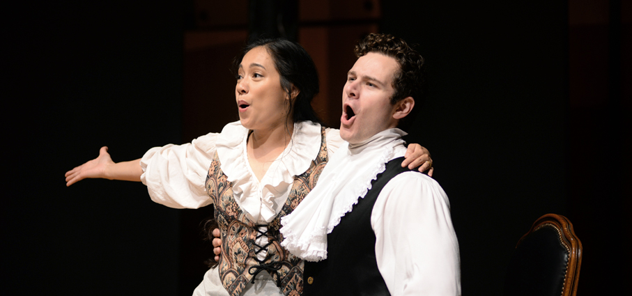 Two students performing in an opera.