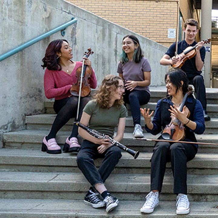 Chamber Ensemble students posing for a photo with their instruments.