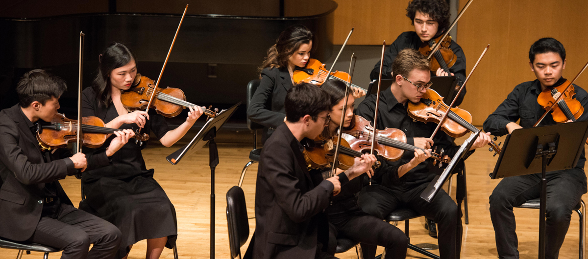 An orchestra performs in Murphy Recital Hall.