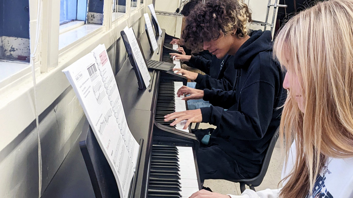 WISH Academy students playing their donated keyboards.