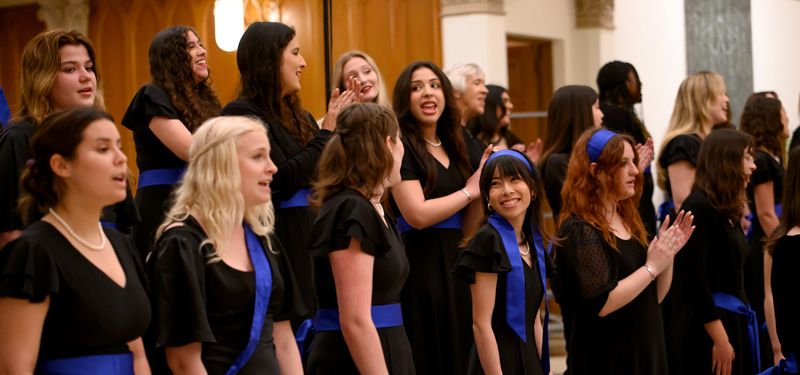 The Oriana Vocal Ensemble performing, accompanied by string instruments.