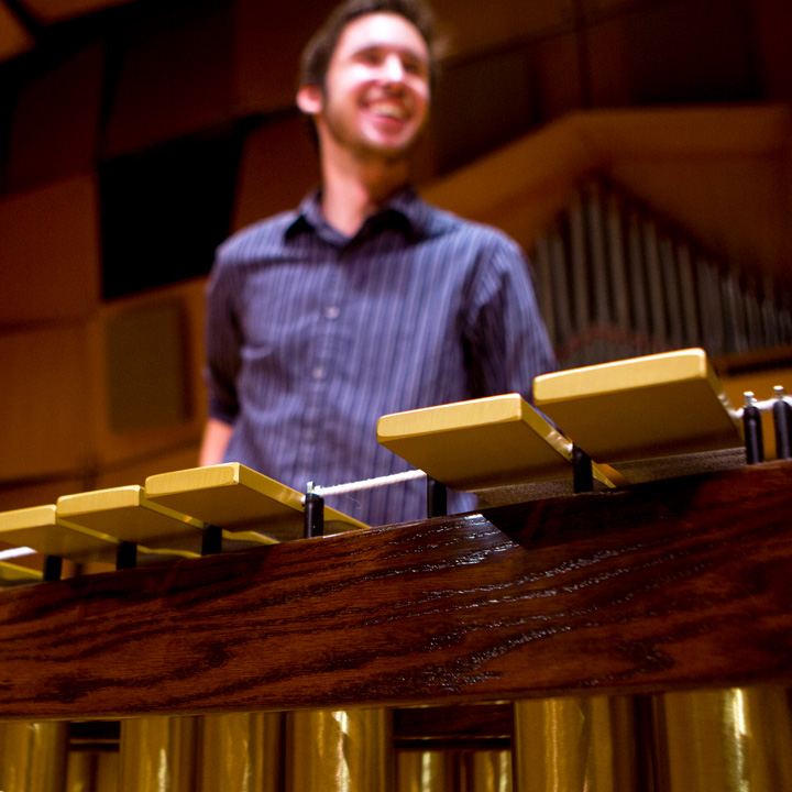 A percussionist standing with a marimba.