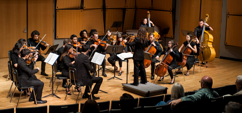 An orchestra performing in Murphy Recital Hall.