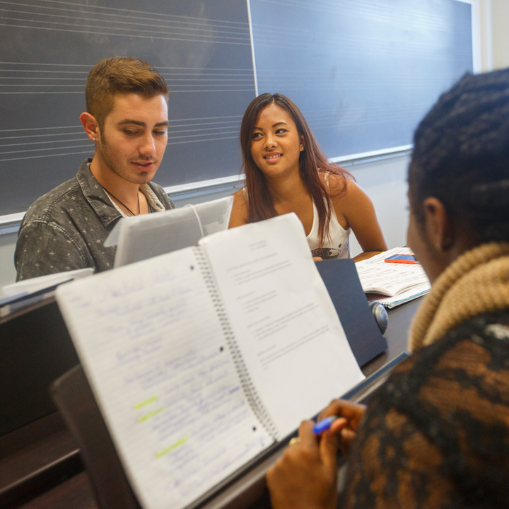 Students working together on an assignment in a music classroom.